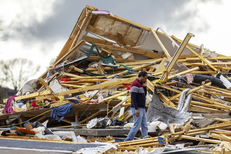 Gopala Penmetsa walks past his house after it was leveled by a tornado near Omaha, Neb., on Friday, April 26, 2024. (Chris Machian/Omaha World-Herald via AP)