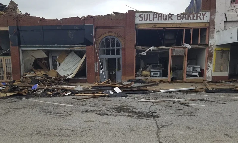 A row of buildings is left damaged by a tornado in Sulphur, Okla., Sunday, April 28, 2024. (AP Photo/Ken Miller)