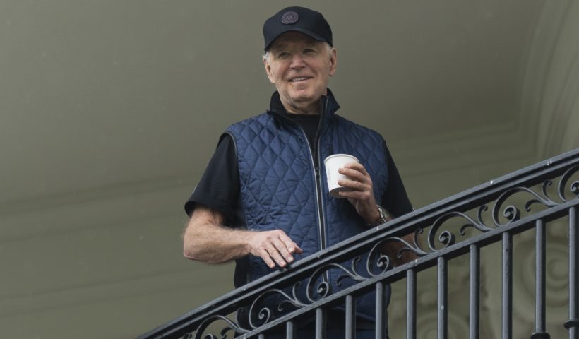 President Joe Biden watches first lady Jill Biden from the White House's Truman Balcony, as she hosts the 2nd annual Joining Forces Military Kids Workout on the South Lawn, Saturday, April 27, 2024. (AP Photo/Manuel Balce Ceneta)