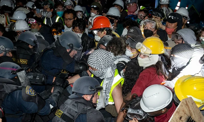 Police advance on pro-Palestinian demonstrators on the UCLA campus Thursday, May 2, 2024, in Los Angeles. (AP Photo/Ethan Swope)
