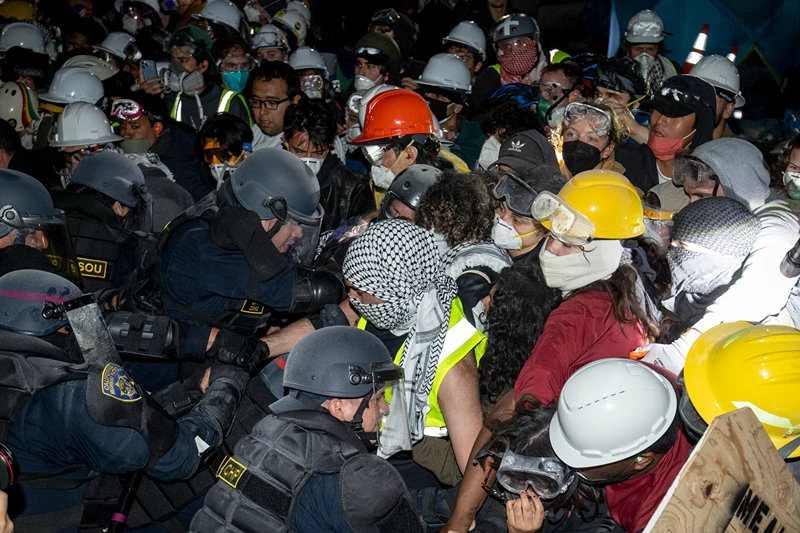 Police advance on pro-Palestinian demonstrators on the UCLA campus Thursday, May 2, 2024, in Los Angeles. (AP Photo/Ethan Swope)