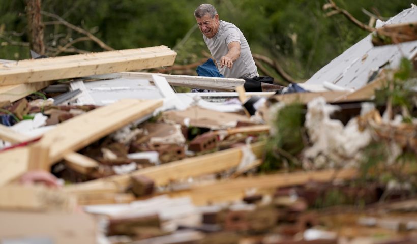 John Bernhardt picks up debris at his stormed damaged home Thursday, May 9, 2024, in Columbia, Tenn. A wave of dangerous storms began crashing over parts of the South on Thursday, a day after severe weather with damaging tornadoes killed several people in the region. (AP Photo/George Walker IV)