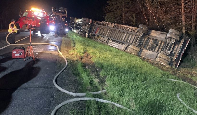 CORRECTS DATE TO MAY 9, NOT MAY 10 - In this image provided by Maine State Police, emergency crews work to remove a tractor-trailer hauling 15 million bees to be used in pollinating the state's blueberry crops after it overturned on Interstate-95, Thursday evening, May 9, 2024, in Clinton, Maine. The driver was taken to a hospital and most of the bees were contained, officials said. (Maine State Police via AP)