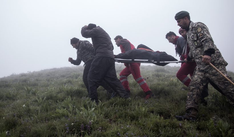 In this photo provided by Moj News Agency, rescue teams members carry the body of a victim after a helicopter carrying Iranian President Ebrahim Raisi crashed in Varzaghan, northwestern Iran, Monday, May 20, 2024. Iranian President Ebrahim Raisi, the country’s foreign minister and others have been found dead at the site of a helicopter crash after an hours-long search through a foggy, mountainous region of the country’s northwest, state media reported. (Azin Haghighi, Moj News Agency via AP)