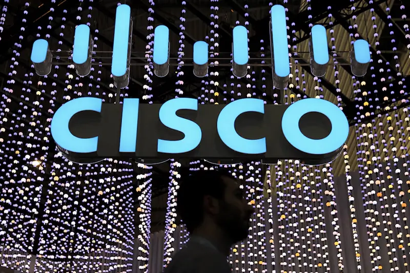 A man passes under a Cisco logo at the Mobile World Congress in Barcelona, Spain February 25, 2019. REUTERS/Sergio Perez/File Photo