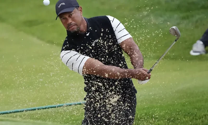 Tiger Woods hits a bunker shot on the 3rd green during a practice round for the PGA Championship golf tournament at Valhalla Golf Club. Mandatory Credit: Sam Upshaw Jr.-USA TODAY Sports