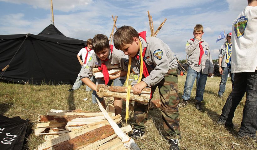 ALMKE, GERMANY - JULY 31: Scoust carry firewood at the camp on July 31, 2010 in Almke near Wolfsburg, Germany. About 5000 young scouts from Germany, Russia, Belgium, Suisse, USA and Italy aged 12 to 20 participate in a camp. Since 1973, the German VCP-Christian Guides and Pathfinders organisation, offers an International historic boys and girls scout meeting during the summer holidays. On a 25 hectare field include 1370 tens, a tent church and a tent theater. The Federal camp is held every four years. (Photo by Andreas Rentz/Getty Images)