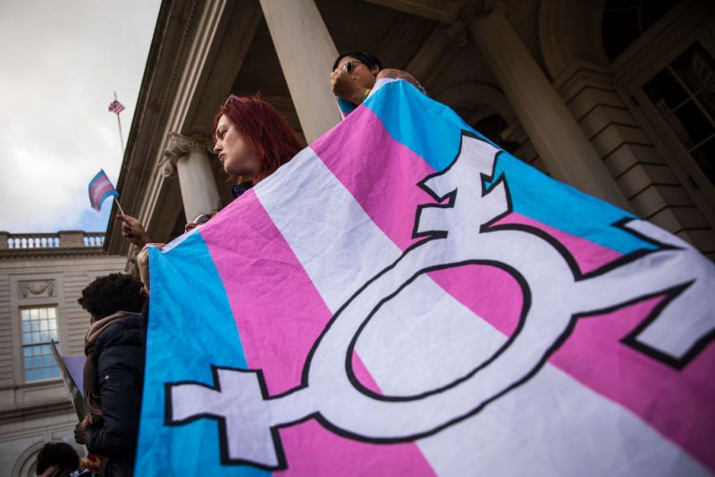 NEW YORK, NY - OCTOBER 24: L.G.B.T. activists and their supporters rally in support of transgender people on the steps of New York City Hall, October 24, 2018 in New York City. The group gathered to speak out against the Trump administration's stance toward transgender people. Last week, The New York Times reported on an unreleased administration memo that proposes a strict biological definition of gender based on a person's genitalia at birth. (Photo by Drew Angerer/Getty Images)