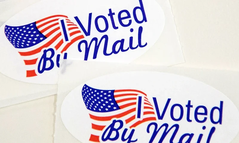 TOPSHOT - Stickers that read "I Voted By Mail" sit on a table waiting to be stuffed into envelopes by absentee ballot election workers at the Mecklenburg County Board of Elections office in Charlotte, NC on September 4, 2020. - The US election is officially open: North Carolina on September 4, 2020 launched vote-by-mail operations for the November 3 contest between President Donald Trump and Joe Biden, which is getting uglier by the day. Worries about the unabated spread of the coronavirus are expected to prompt a major increase in the number of ballots cast by mail, as Americans avoid polling stations. (Photo by Logan Cyrus / AFP) (Photo by LOGAN CYRUS/AFP via Getty Images)