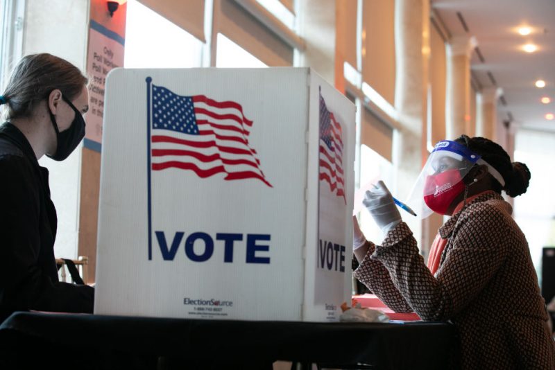 ATLANTA, GA - NOVEMBER 03: A poll worker helps K. Maki (left) fill out a provisional ballot at Park Tavern polling station on November 3, 2020 in Atlanta, Georgia. After a record-breaking early voting turnout, Americans head to the polls on the last day to cast their vote for incumbent U.S. President Donald Trump or Democratic nominee Joe Biden in the 2020 presidential election. (Photo by Jessica McGowan/Getty Images)