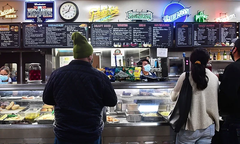 Servers take customer's orders at Philippe's, a downtown Los Angeles restaurant in business since 1908 famed for its "French Dipped Sandwich", in Los Angeles, California on December 10, 2021. - US consumer prices rose last month at a rate not seen in nearly 40 years, the government reported Friday, underscoring how inflation threatens the world's largest economy and President Joe Biden's public support. (Photo by Frederic J. BROWN / AFP) (Photo by FREDERIC J. BROWN/AFP via Getty Images)