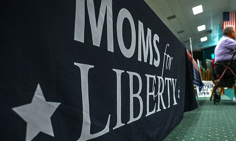 People and members of the "Moms For Liberty" Association, attend a campaign event for Jacqueline Rosario, to be re-elected as a member of the school board for District 2, in Vero Beach, Florida, on October 16, 2022. - Rosario's candidacy for re-election to a school board is supported by the controversial group "Moms for Liberty", which claims to defend the "rights of parents" but is accused by its critics of opposing LGBT rights. Long dormant and apolitical institutions, these councils, whose members are elected, have become real powder kegs with the politicization of subjects such as the discussion of gender or sexuality in schools, or the teaching of racism. Education has been at the heart of some mid-term elections. (Photo by Giorgio VIERA / AFP) (Photo by GIORGIO VIERA/AFP via Getty Images)