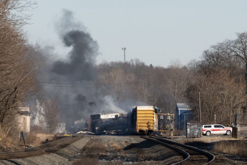Smoke rises from a derailed cargo train in East Palestine, Ohio, on February 4, 2023. - The train accident sparked a massive fire and evacuation orders, officials and reports said Saturday. No injuries or fatalities were reported after the 50-car train came off the tracks late February 3 near the Ohio-Pennsylvania state border. The train was shipping cargo from Madison, Illinois, to Conway, Pennsylvania, when it derailed in East Palestine, Ohio. (Photo by DUSTIN FRANZ / AFP) (Photo by DUSTIN FRANZ/AFP via Getty Images)