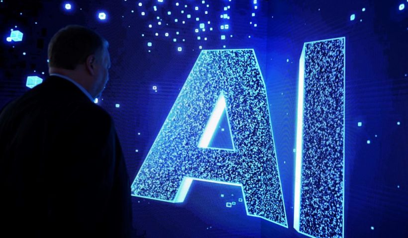 A visitor watches an AI (Artificial Intelligence) sign on an animated screen at the Mobile World Congress (MWC), the telecom industry's biggest annual gathering, in Barcelona. (Photo by Josep LAGO / AFP) (Photo by JOSEP LAGO/AFP via Getty Images)