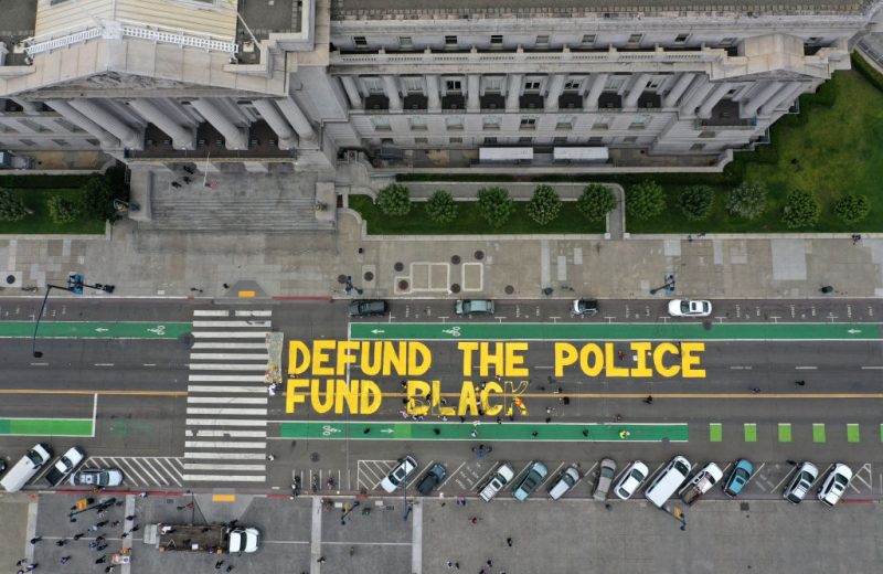SAN FRANCISCO, CALIFORNIA - JULY 20: Protesters paint a mural that says 'defund the police' during a Strike For Black Lives demonstration outside of San Francisco City Hall on July 20, 2020 in San Francisco, California. The demonstration was part of the nationwide Strike for Black Lives effort which is calling for higher wages, better jobs, and Unions to help workers build economic power. (Photo by Justin Sullivan/Getty Images)