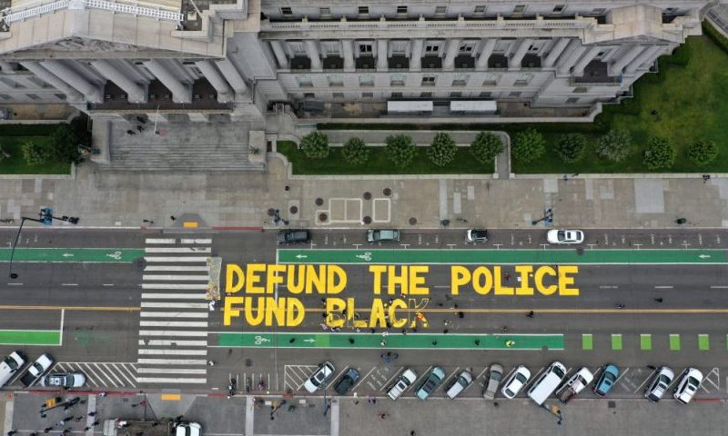 SAN FRANCISCO, CALIFORNIA - JULY 20: Protesters paint a mural that says 'defund the police' during a Strike For Black Lives demonstration outside of San Francisco City Hall on July 20, 2020 in San Francisco, California. The demonstration was part of the nationwide Strike for Black Lives effort which is calling for higher wages, better jobs, and Unions to help workers build economic power. (Photo by Justin Sullivan/Getty Images)