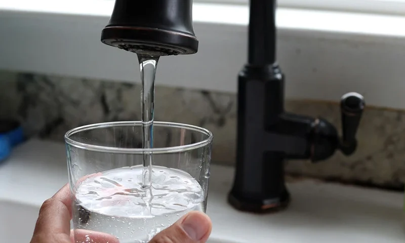 SAN ANSELMO, CALIFORNIA - JULY 06: In this photo illustration, water from a tap fills a glass on July 06, 2023 in San Anselmo, California. According to a study by the US Geological Survey, nearly half of the tap water in the United States is contaminated with "forever chemicals" that are considered dangerous to human health. Per and polyfluorinated alkyl substances, or PFAS, are chemicals that linger in the body and are linked to health issues like cancer, obesity, liver damage, decreased fertility, thyroid disease, high cholesterol and hormone suppression. (Photo Illustration by Justin Sullivan/Getty Images)
