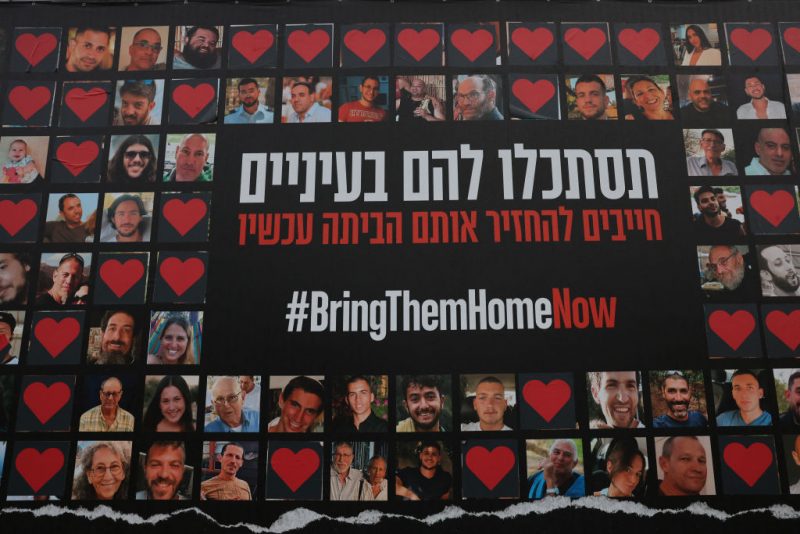 TOPSHOT - A wall is covered by a large poster bearing pictures of Israeli hostages held by the Hamas movement since October 7, in Jerusalem on February 2, 2024, amid ongoing battles between Israel and the militant group Hamas. (Photo by AHMAD GHARABLI / AFP) (Photo by AHMAD GHARABLI/AFP via Getty Images)