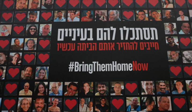 TOPSHOT - A wall is covered by a large poster bearing pictures of Israeli hostages held by the Hamas movement since October 7, in Jerusalem on February 2, 2024, amid ongoing battles between Israel and the militant group Hamas. (Photo by AHMAD GHARABLI / AFP) (Photo by AHMAD GHARABLI/AFP via Getty Images)