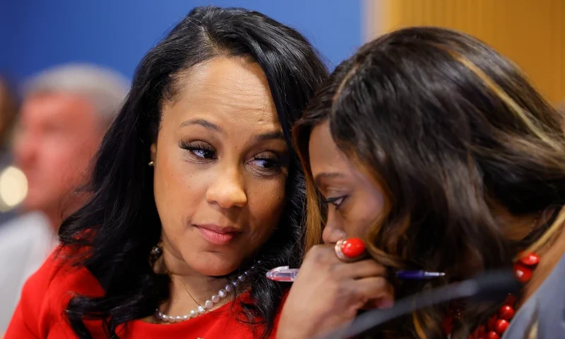 ATLANTA, GA - MARCH 01: Fulton County District Attorney Fani Willis, left and prosecutor Daysha Young, right, speak to each other during a hearing in the case of the State of Georgia v. Donald John Trump at the Fulton County Courthouse on March 1, 2024, in Atlanta, Georgia. The hearing is to determine whether Fulton County District Attorney Fani Willis should be removed from the case because of a relationship with Nathan Wade, special prosecutor she hired in the election interference case against former President Donald Trump. (Photo by Alex Slitz-Pool/Getty Images)