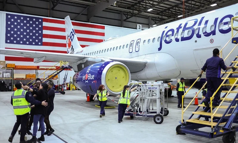 Employees of Jet Blue airlines work around an Airbus A320 passenger aircraft in a maintenance hangar of the company at JFK International Airport in New York on March 4, 2024, prior of a Career Discovery Week event. JetBlue and Spirit Airlines formally pulled the plug Monday on their merger, about six weeks after a federal judge ruled it violated US antitrust law. (Photo by Charly TRIBALLEAU / AFP) (Photo by CHARLY TRIBALLEAU/AFP via Getty Images)