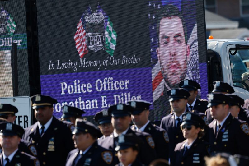 MASSAPEQUA, NEW YORK - MARCH 30: People attend the funeral of NYPD officer Jonathan Diller at St. Rose of Lima R.C. Church on March 30, 2024 in Massapequa, New York. Officer Diller was killed on March 25th when he was shot in Queens after approaching an illegally parked vehicle. Two suspects have been arrested, charged and are being held and without bail for the murder of Diller. (Photo by Michael M. Santiago/Getty Images)