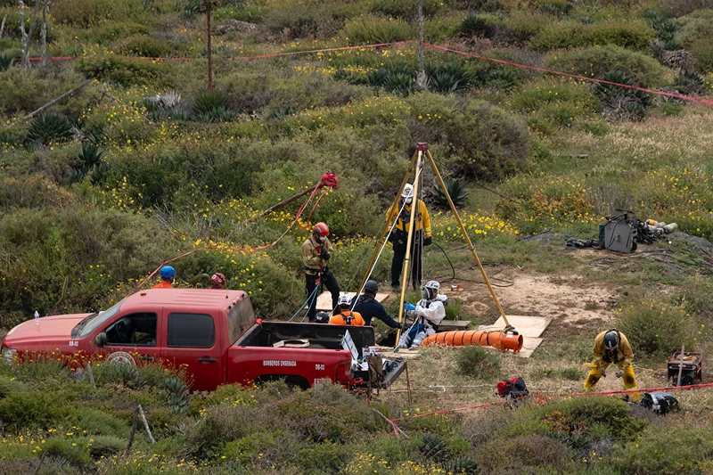 MEXICO-US-AUSTRALIA-MISSING-SURFERS
A rescue worker descends into a waterhole where human remains were found near La Bocana Beach, Santo Tomas delegation, in Ensenada, Baja California State, Mexico, on May 3, 2024. . The FBI said on Friday that three bodies were found in Mexico's Baja California, near an area where two Australians and an American went missing last week during a surfing trip. "We confirm there were three individuals found deceased in Santo Tomas, Baja California," a statement from the FBI's office in San Diego said without providing identities of the victims. (Photo by Guillermo Arias / AFP) (Photo by GUILLERMO ARIAS/AFP via Getty Images)
