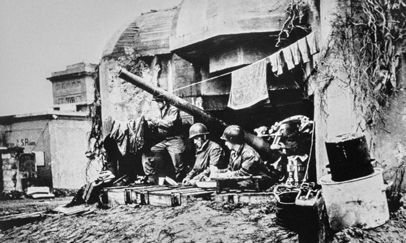 US soldiers maintain their position and do their laundry after taking control of a German bunker located on the Cherbourg peninsula, in June 1944, following the Allied landings in Normandy. The invasion of Normandy was launched on June 6, 1944, with the simultaneous landing of American, Canadian and British forces spread across five separate beachheads in Normandy. Also called Operation Overlord, this massive military operation was a major success for Allied troops, allowing them to break through the Wehrmacht defenses and force their way to Paris in August 1944. (Photo by US National Archives / AFP) (Photo by -/US National Archives/AFP via Getty Images)