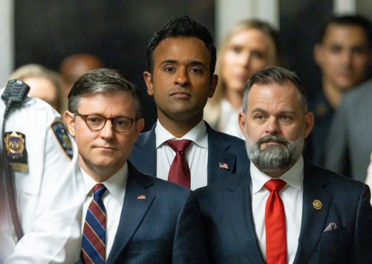NEW YORK, NEW YORK - MAY 14: US Speaker of the House Mike Johnson (C) and businessman Vivek Ramaswamy (3-L) listen as former U.S. President Donald Trump (C) talks with reporters as he arrives for his trial for allegedly covering up hush money payments linked to an extramarital affair with Stormy Daniels, at Manhattan Criminal Court on May 14, 2024 in New York City. Former U.S. President Donald Trump faces 34 felony counts of falsifying business records in the first of his criminal cases to go to trial. (Photo by Justin Lane - Pool/Getty Images)