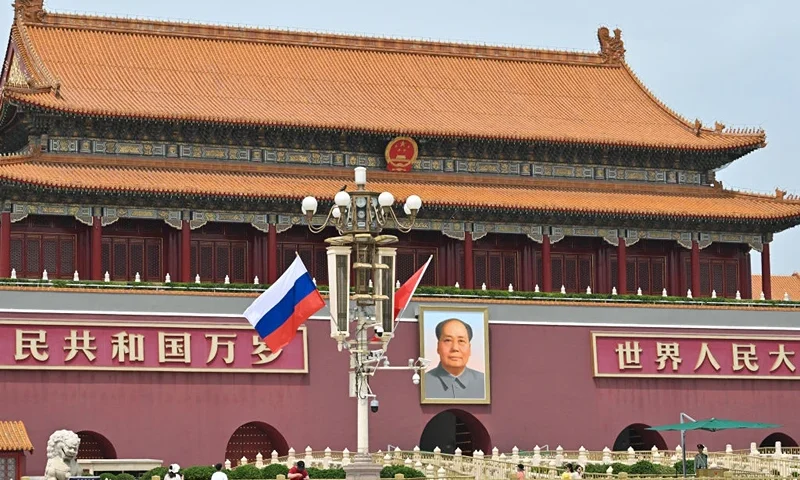TOPSHOT - Russia's national flag flies beside the Chinese flag in front of Tiananmen Gate next to Tiananmen Square, during the state visit of Russia's president Vladimir Putin in Beijing on May 16, 2024. Leaders Xi Jinping and Vladimir Putin framed their nations' ties as a stabilising force in a chaotic world as they met May 16 in Beijing, where the Russian president is seeking greater Chinese support for his war effort in Ukraine and isolated economy. (Photo by HECTOR RETAMAL / AFP) (Photo by HECTOR RETAMAL/AFP via Getty Images)