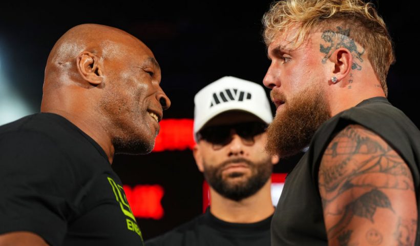 ARLINGTON, TEXAS - MAY 16: (L-R) Mike Tyson, Nakisa Bidarian and Jake Paul pose onstage during the Jake Paul vs. Mike Tyson Boxing match Arlington press conference at Texas Live! on May 16, 2024 in Arlington, Texas. (Photo by Cooper Neill/Getty Images for Netflix)