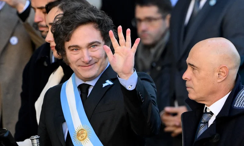 ARGENTINA-POLITICS-TEDEUM-MILEI Argentina's President Javier Milei waves to media as he arrives to the Metropolitan Cathedral in Buenos Aires on May 25, 2024, to attend a Te Deum in commemoration of the 214th anniversary of the May Revolution that led to the independence of Argentina from Spain. (Photo by Luis ROBAYO / AFP) (Photo by LUIS ROBAYO/AFP via Getty Images)