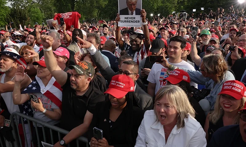 NEW YORK, NEW YORK - MAY 23: Supporters of former President Donald Trump watch as he holds a rally in the historical Democratic district of the South Bronx on May 23, 2024 in New York City. The Bronx, home to a large Latino community, has been a Democratic base for generations of voters and the rally comes as Trump looks to attract more non-white voters. A Manhattan jury is set to begin deliberations on whether to convict Trump of felony charges in his criminal hush money trial. (Photo by Spencer Platt/Getty Images)