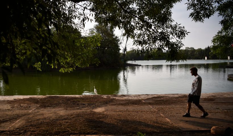 A man walks around Chapultepec's lake in Mexico City on May 30, 2024. (Photo by Rodrigo Oropeza / AFP) (Photo by RODRIGO OROPEZA/AFP via Getty Images)