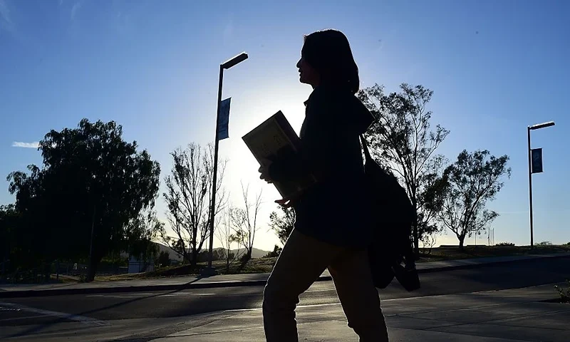 Chinese student Helen Zhou, from Chengdu, heads to Choir practice on campus at Linfield Christian School in Temecula, California on March 23, 2016. Growing up in mainland China, Hailun "Helen" Zhou always knew that she would finish her high school education in America, whatever the cost. But for thousands of Chinese teens flocking to US schools, the pursuit of the American dream can sometimes turn into a nightmare. / AFP / FREDERIC J. BROWN (Photo credit should read FREDERIC J. BROWN/AFP via Getty Images)