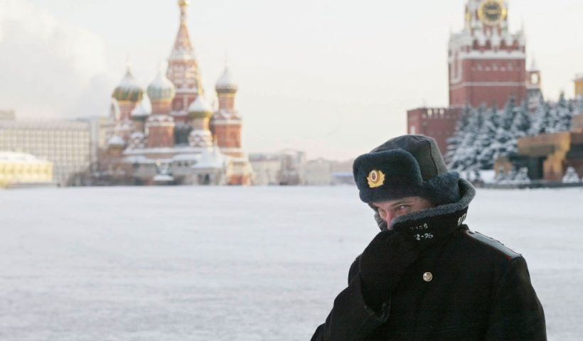 MOSCOW - JANUARY 7: A Russian police officer, braving the bitter cold, patrols Red Square with the Kremlin in the background January 7, 2003 in Moscow. Temperatures fell to 27 degrees below zero Celcius (17 below zero Fahrenheit) in Moscow. (Photo by Oleg Nikishin/Getty Images)