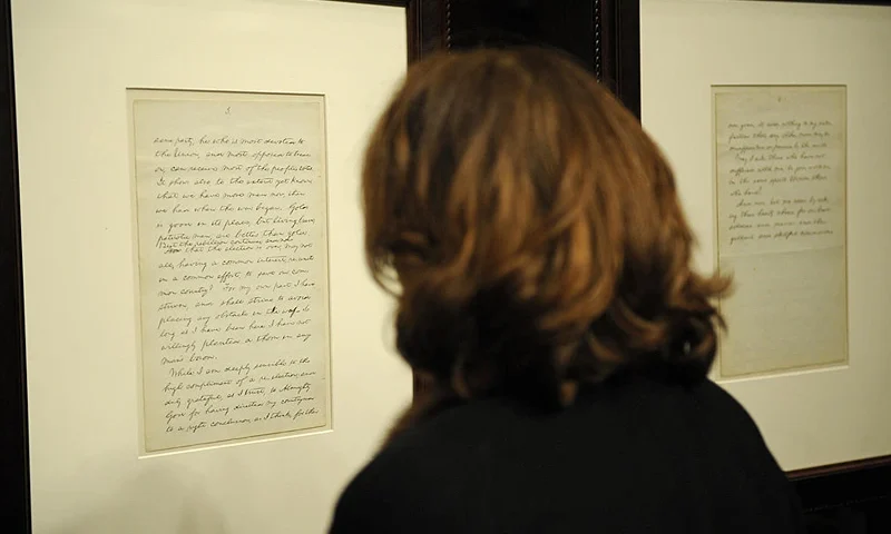 A woman reads part of a rare manuscript by Abraham Lincoln's 1864 reelection victory speech (Lot 51), calling on the country to unite amid civil war in 1864, which is on display during an auction at Christie's in New York, February 12, 2009. The manuscript sold for 3.4 million dollars, after commission, a world record for an US historical document during the sale which took place on the 200th anniversary of Lincoln's birth. AFP PHOTO/Emmanuel Dunand (Photo credit should read EMMANUEL DUNAND/AFP via Getty Images)