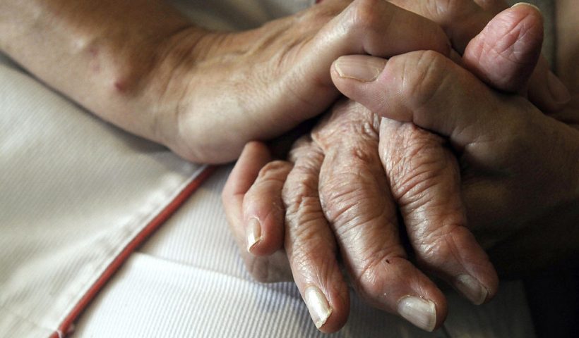 A nurse holds the hands of a person suffering from Alzheimer's disease on September 21, 2009 at Les Fontaines retirement home in Lutterbach , eastern France. Scientists working in seven countries announced last week they had uncovered variants of three genes which play a role in Alzheimer's, a discovery that should throw open many new avenues for tackling this mind-killing disease. AFP PHOTO / SEBASTIEN BOZON (Photo credit should read SEBASTIEN BOZON/AFP via Getty Images)