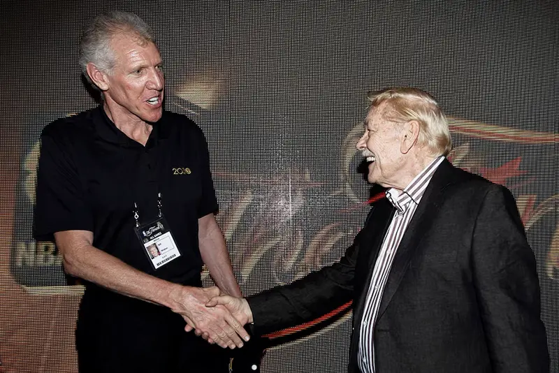 Fomer NBA star Bill Walton (L) talks with Los Angeles Lakers team owner Jerry Buss after the Lakers defeated the Boston Celtics in Game 7 of the 2010 NBA Finals basketball series in Los Angeles, California June 17, 2010. REUTERS/Mike Blake/File Photo