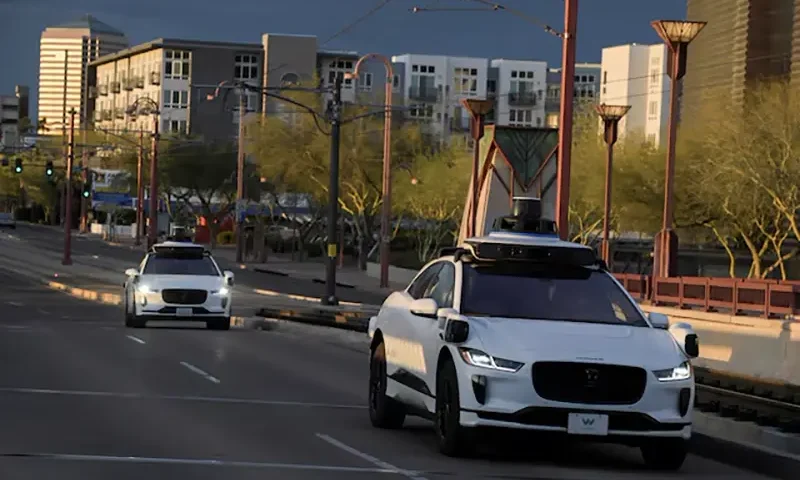Two Waymo autonomous vehicles drive themselves down Central Avenue in Phoenix, Arizona, U.S., March 18, 2024. REUTERS/Caitlin O'Hara/File Photo