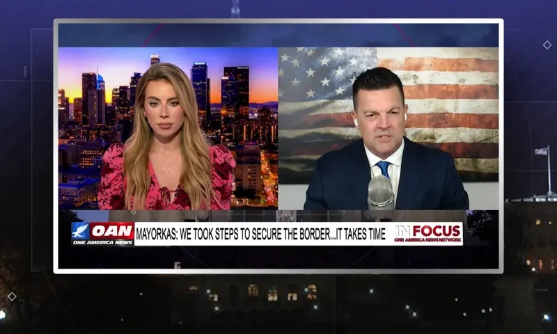 Video still from In Focus on One America News Network showing a split screen of the host on the left side, and on the right side is the guest, J.J. Carrell.