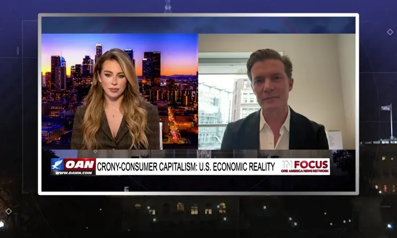 Video still from In Focus on One America News Network showing a split screen of the host on the left side, and on the right side is the guest, Johan Norberg.