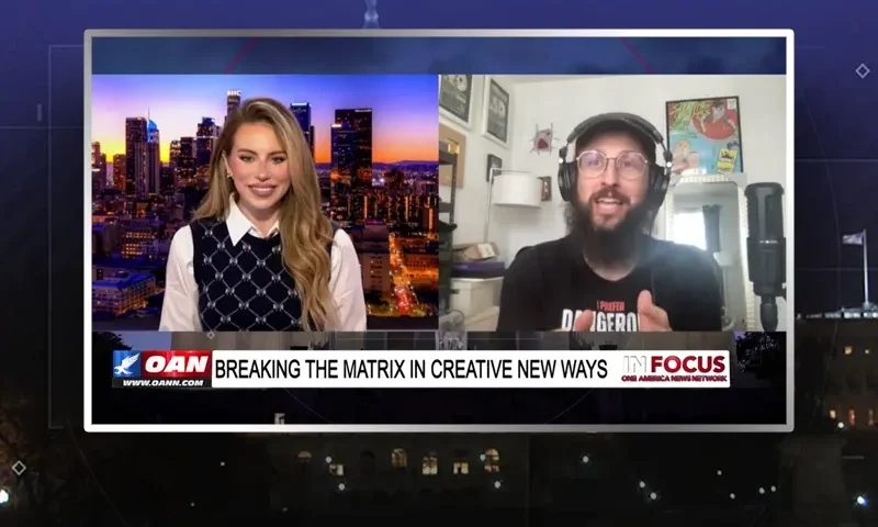 Video still from In Focus on One America News Network showing a split screen of the host on the left side, and on the right side is the guest, Hi-Rez the Rapper.