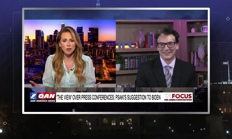 Video still from In Focus on One America News Network showing a split screen of the host on the left side, and on the right side is the guest, Eric Scheiner.