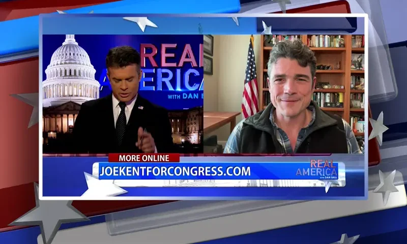 Video still from Real America on One America News Network showing a split screen of the host on the left side, and on the right side is the guest, Joe Kent.
