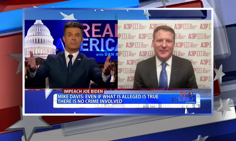 Video still from Real America on One America News Network showing a split screen of the host on the left side, and on the right side is the guest, Mike Davis.