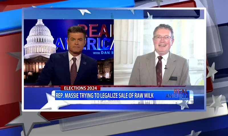 Video still from Real America on One America News Network showing a split screen of the host on the left side, and on the right side is the guest, Rep. Thomas Massie.