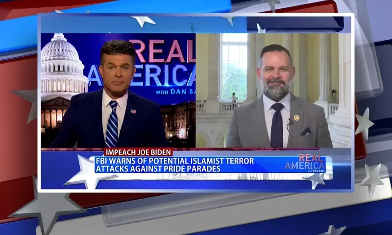 Video still from Real America on One America News Network showing a split screen of the host on the left side, and on the right side is the guest, Rep. Cory Mills.