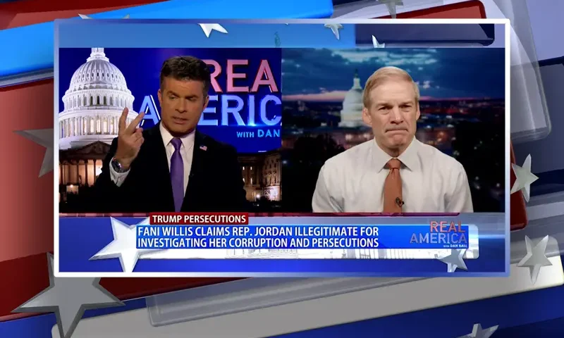 Video still from Real America on One America News Network showing a split screen of the host on the left side, and on the right side is the guest, Rep. Jim Jordan.