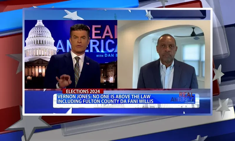Video still from Real America on One America News Network showing a split screen of the host on the left side, and on the right side is the guest, Vernon Jones.